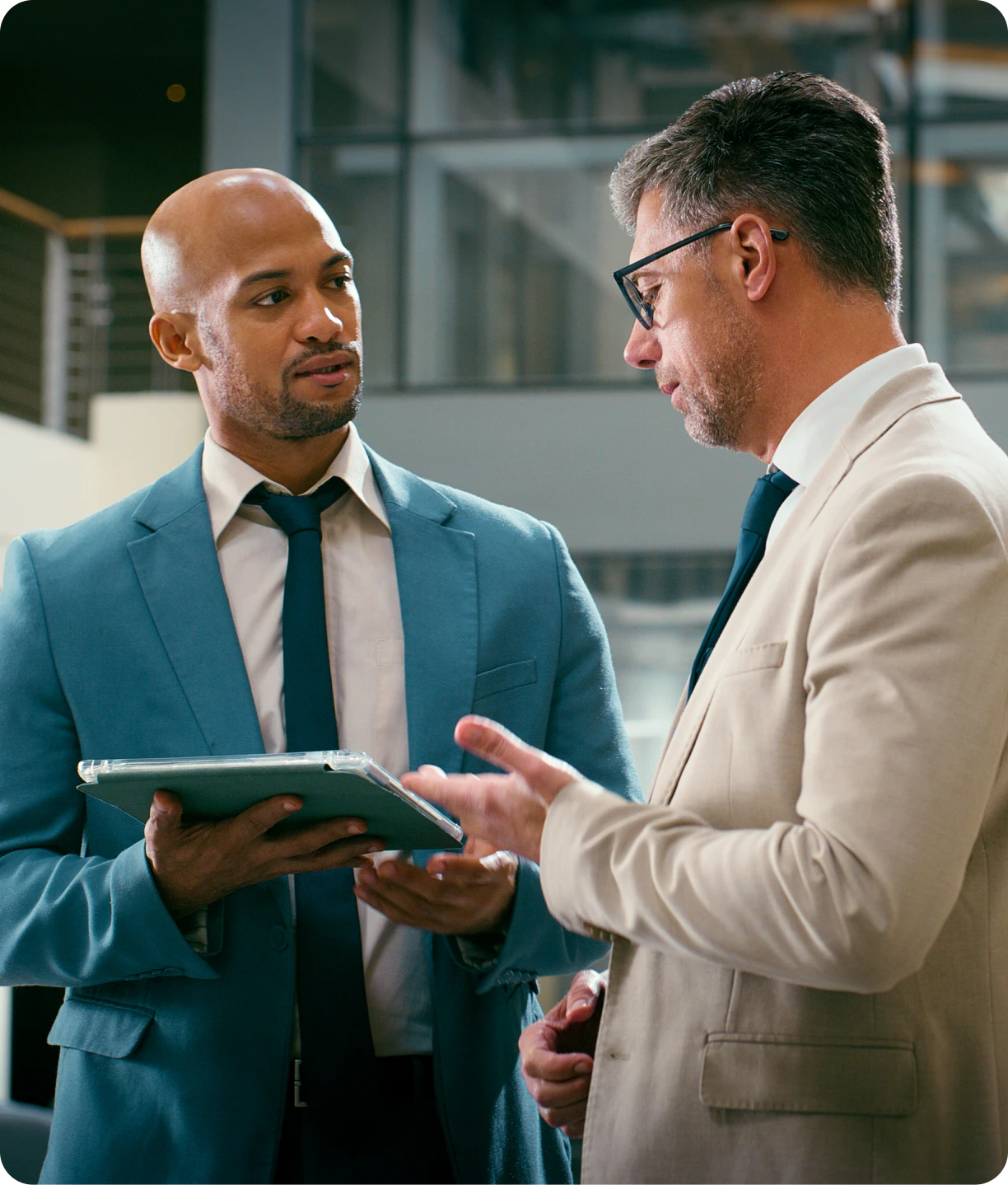 Two businessmen discussing with a tablet