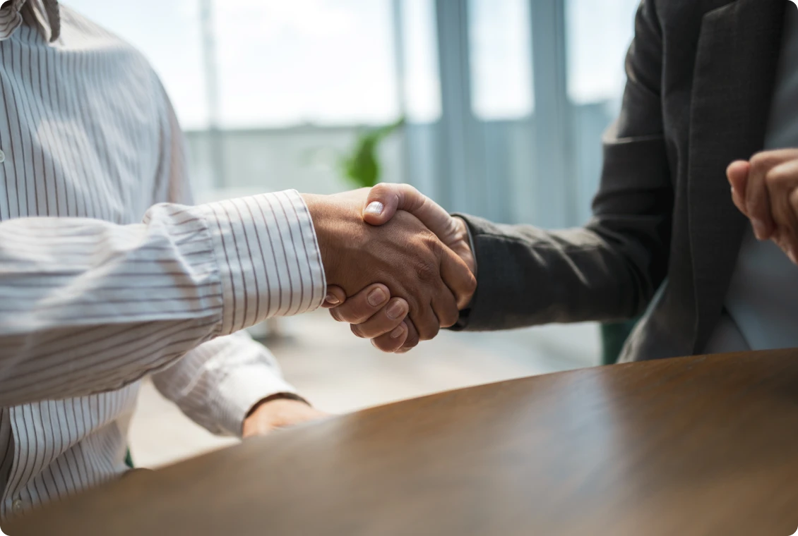 Business handshake in office setting
