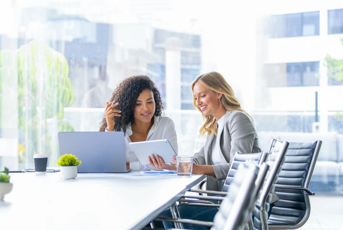 Colleagues collaborating with tablet in office